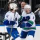 Vancouver Canucks' J.T. Miller (9) celebrates with Quinn Hughes (43) after scoring during the first period of an NHL hockey game against the New York Rangers, Monday, Jan. 8, 2024, in New York.