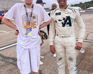 Brendon poses for a photo with NASCAR driver Armani Williams at a NASCAR Cup Series race at the New Hampshire Motorspeedway in New Hampshire. [Provided by Cole Klassen]