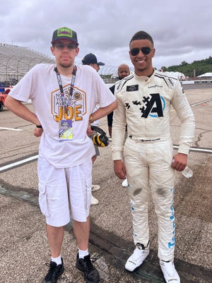 Brendon poses for a photo with NASCAR driver Armani Williams at a NASCAR Cup Series race at the New Hampshire Motorspeedway in New Hampshire. [Provided by Cole Klassen]