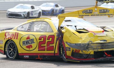 NASCAR Cup Series driver Joey Logano (22) is towed after crashing in the first turn Sunday, July 21, 2024, during the Brickyard 400 at Indianapolis Motor Speedway.