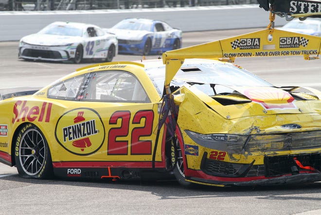 NASCAR Cup Series driver Joey Logano (22) is towed after crashing in the first turn Sunday, July 21, 2024, during the Brickyard 400 at Indianapolis Motor Speedway.